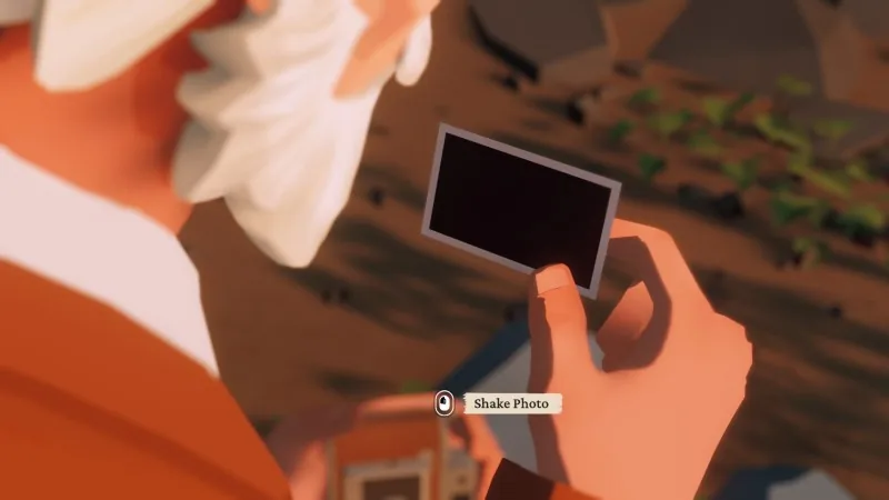 Alfred holding the undeveloped instant photograph